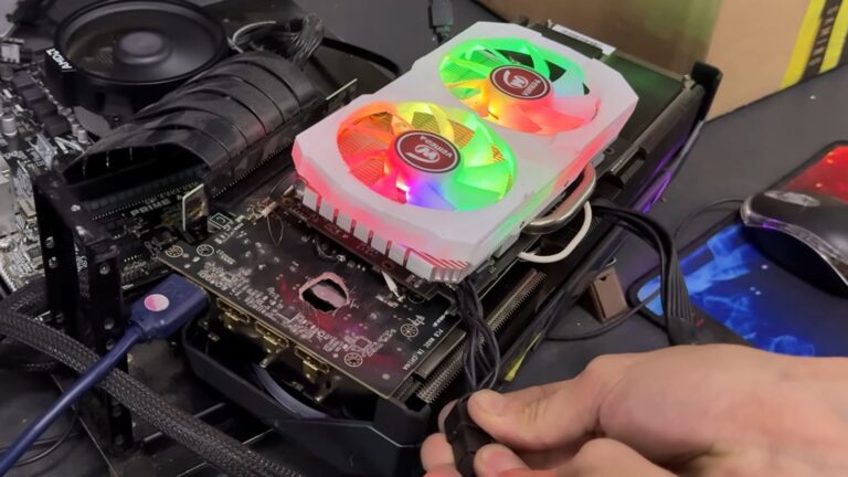 This RTX 5070 Ti with a literal hole in it has been kept on life support by a spliced-in AMD RX 580, because no GPU gets left behind